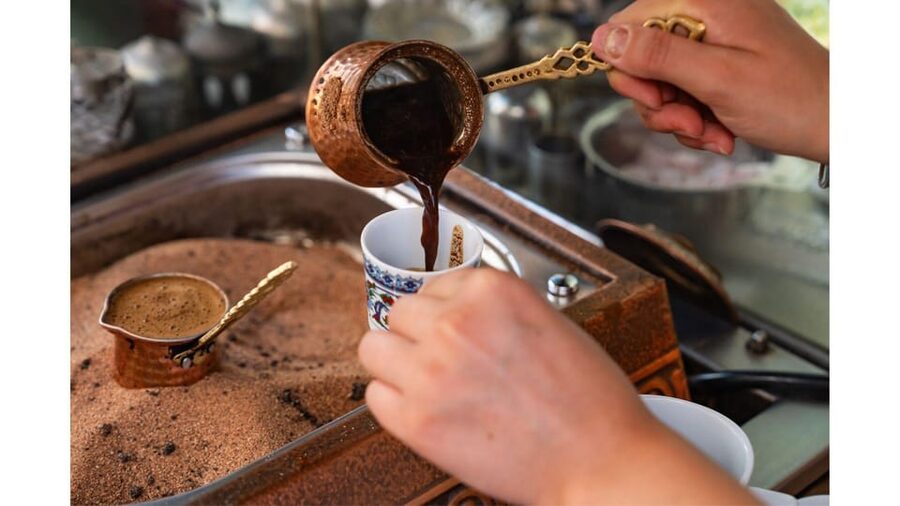 Cappadocia: Sand-Brewed Turkish Coffee Workshop - Preparing the cezve over hot sand